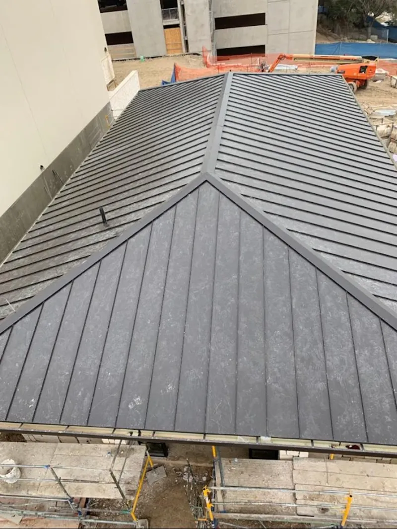 Commercial metal roof construction with crane equipment in Freetown