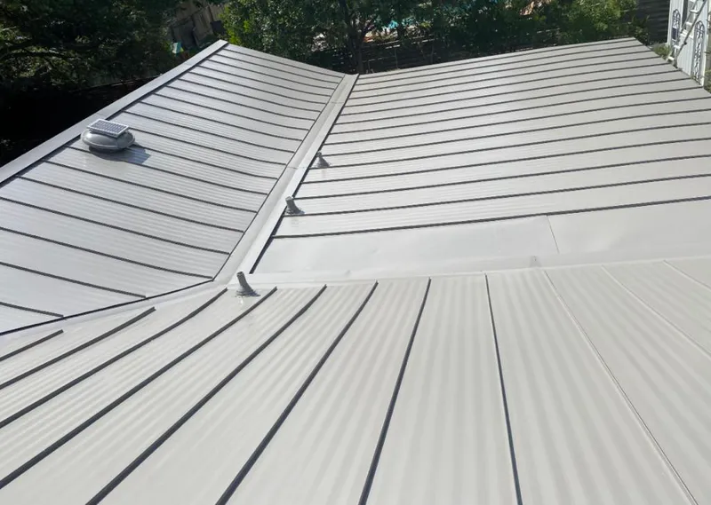 Solar attic fan installed on a metal roof for Roof Ventilation in Freetown